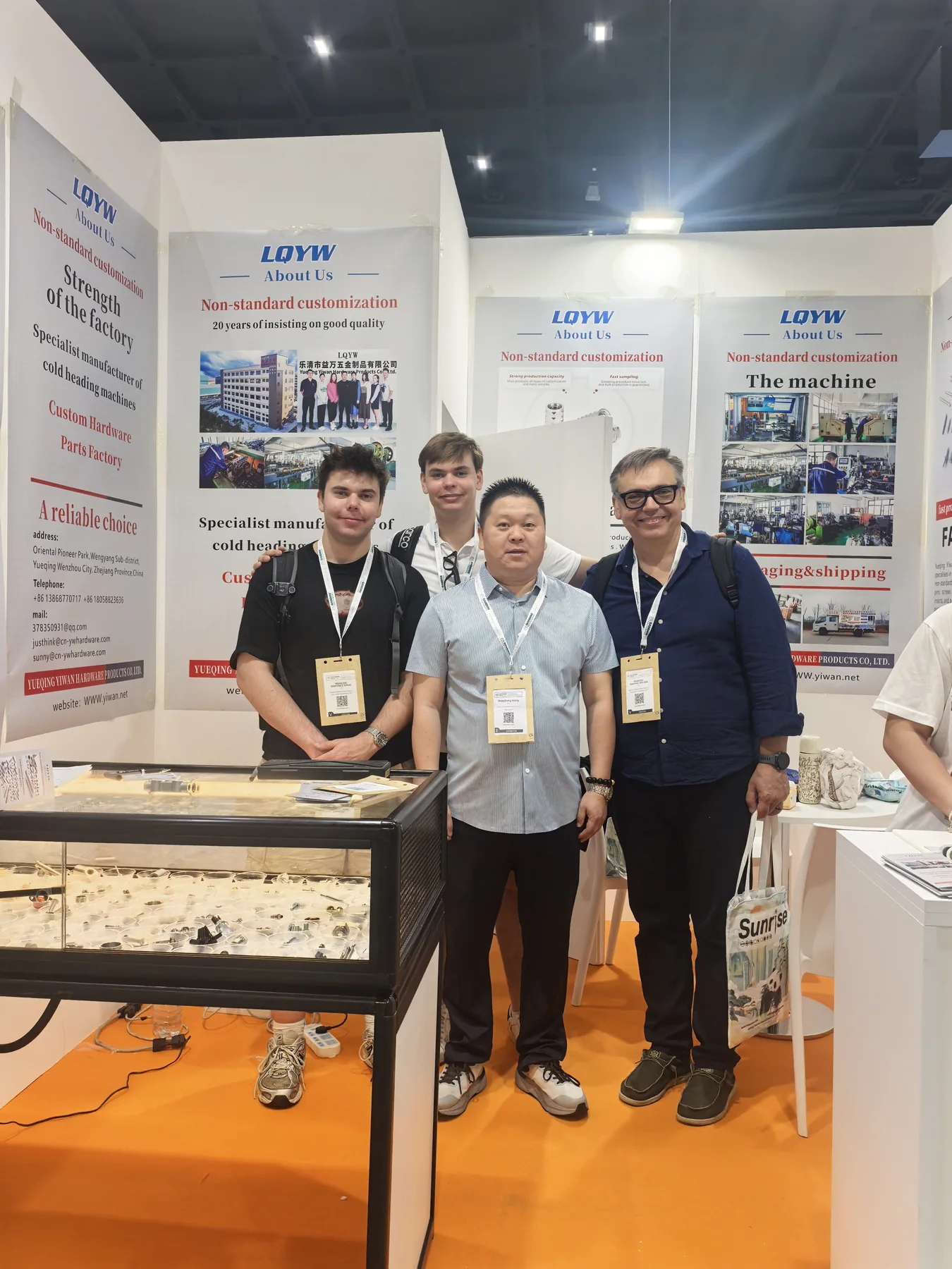 YIWAN representatives with the hardware display at Fastener Fair Milan