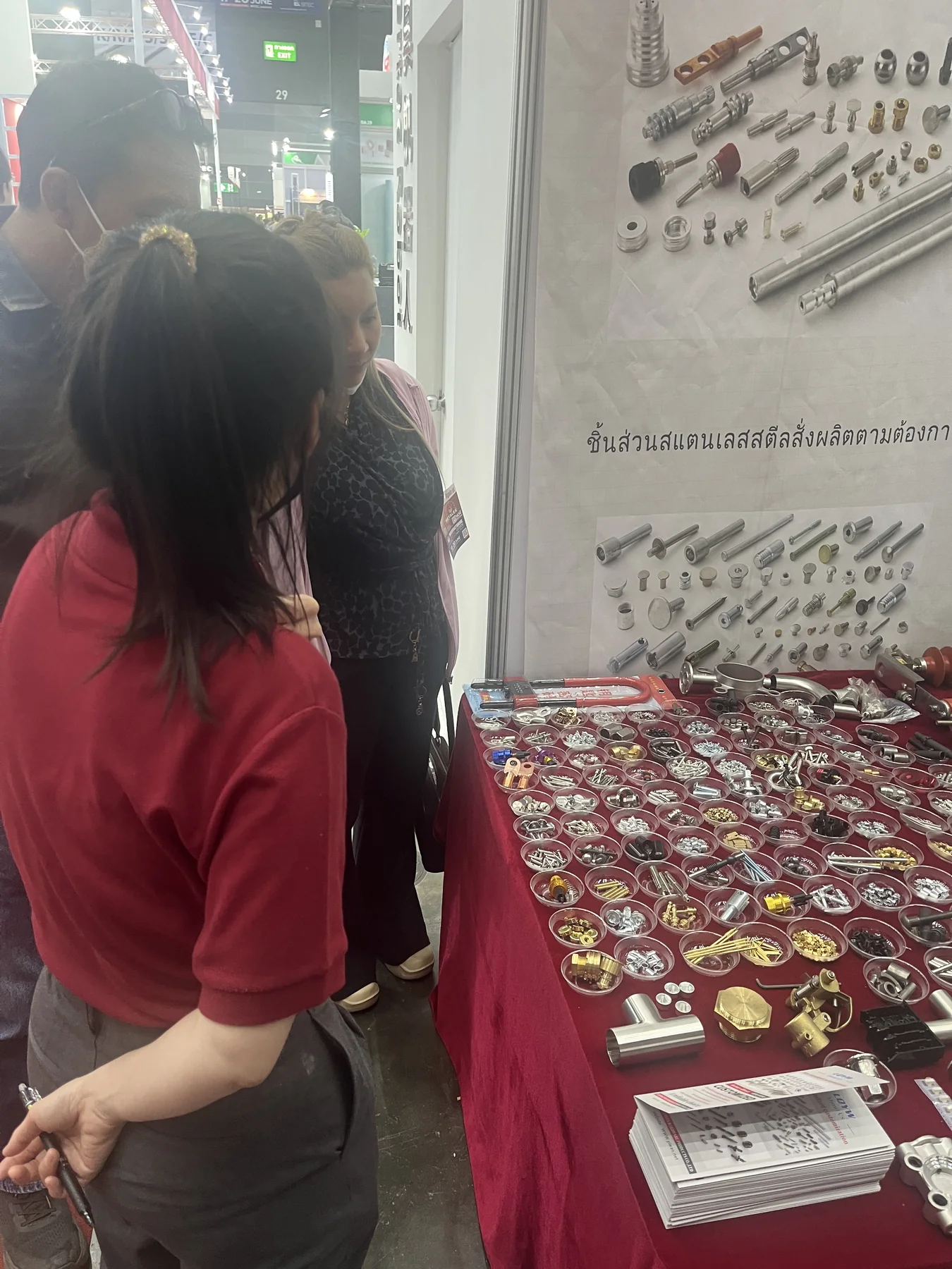Visitors examining YIWAN rivet samples at the 2025 Bangkok exhibition