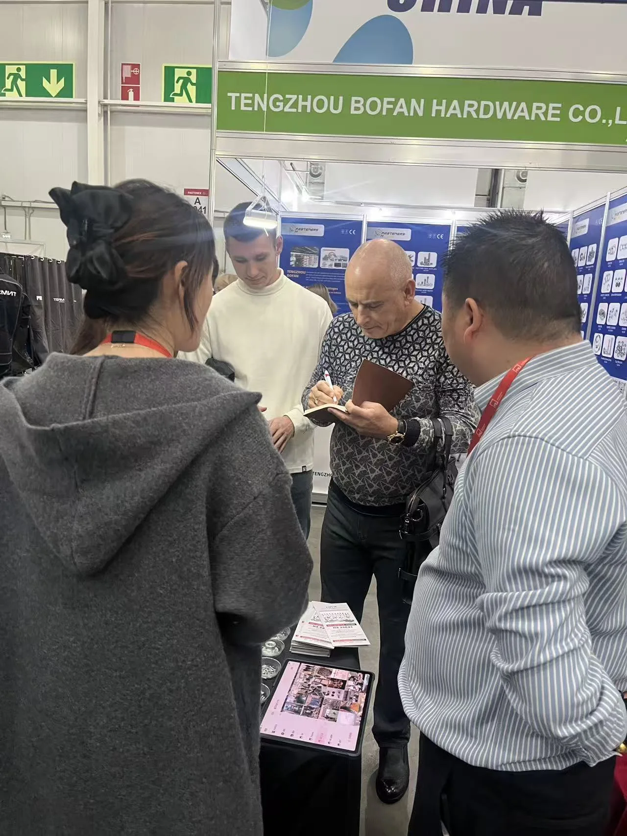 Buyer reviewing YIWAN fastener samples at the Moscow exhibition