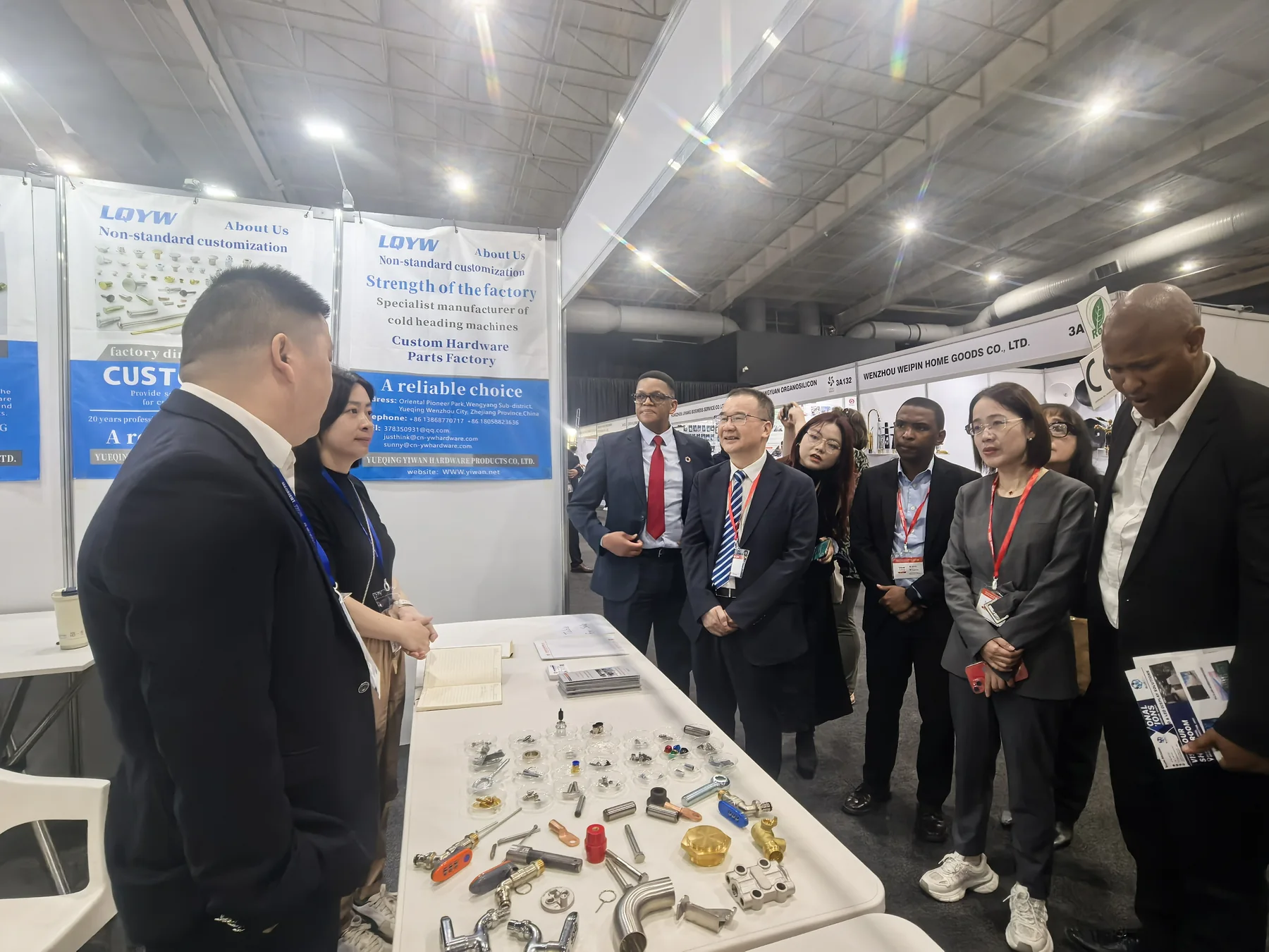 Visitors reviewing hardware samples at the YIWAN South Africa exhibition booth